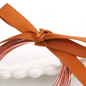 Set de pulseras de silicona con purpurina naranja brillante y lazo de cinta de satén