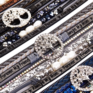 Close-up of multilayer leather tree of life bracelet with rhinestones and engraved slogans