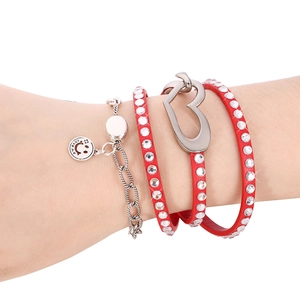 Close-up of red leather layered bracelet with sparkling rhinestones and heart buckle
