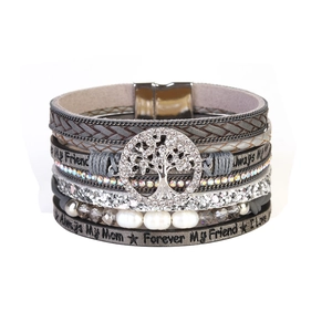 Close-up of tree of life charm and sentimental engraving on multi-layer wrap bracelet