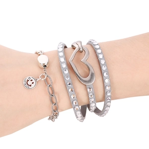 Detail of grey multi-layer leather bracelet with crystal inlay and heart charm