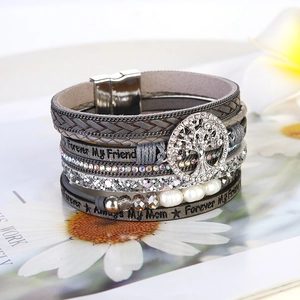 Detail of grey multilayer leather bracelet featuring sparkling tree of life and magnet clasp