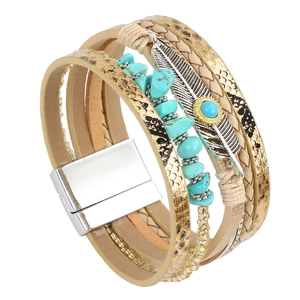 Detail of bohemian leather wrap bracelet with silver feather charm and turquoise beads