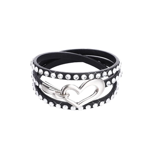 Detail of multi-layer black leather wrap bracelet with silver rhinestone heart buckle