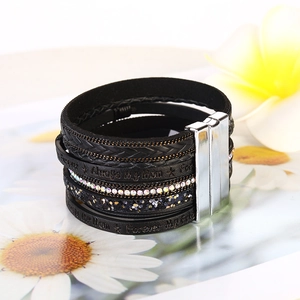 Detail of multi-layer leather bracelet with tree of life charm and magnetic buckle