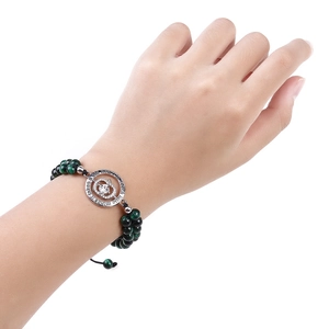 Detail of beaded teacher bracelet with big heart engraving and green tiger eye stones