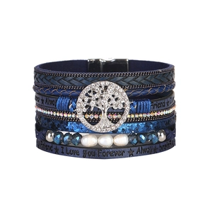 Macro shot of blue leather bracelet with Tree of Life charm and I Love You Forever text