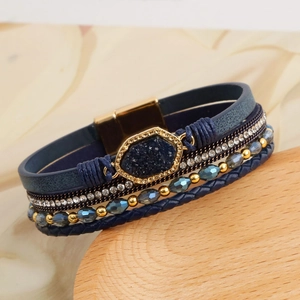 Detail view of multi-layer boho bracelet with blue stones and gold magnetic buckle