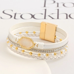 Elegant multi-layer white wrap bracelet with gold accents and sparkling rhinestones