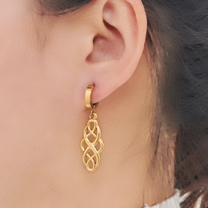 Elegant gold-plated stainless steel drop earrings with a Celtic knot design on a model