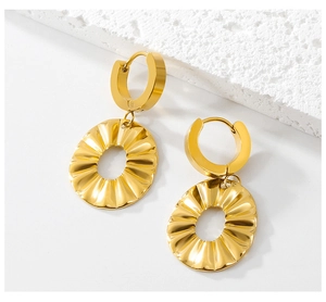 Detail view of gold ruffle earrings with radial texture and hollow oval drop design