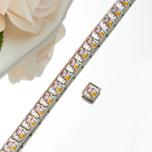 Close-up of modular stainless steel bracelet links with colorful enamel house patterns