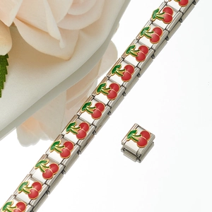 Detail of Italian charm bracelet with red cherry enamel patterns and stainless steel links