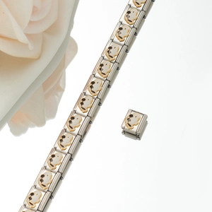 Close-up of Italian charm bracelet featuring gold Snoopy motifs on stainless steel links