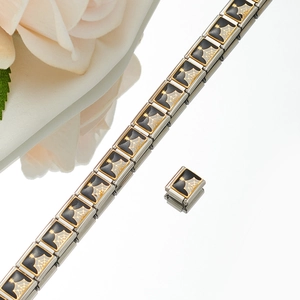 Detail of Italian charm bracelet link with gold spider web pattern and black enamel