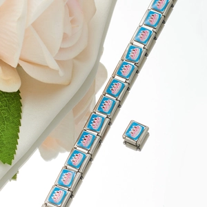 Macro detail of Italian style modular link bracelet with a blue birthday cake enamel charm