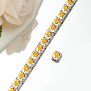 Detailed close-up of modular stainless steel link bracelet with yellow enamel star charms