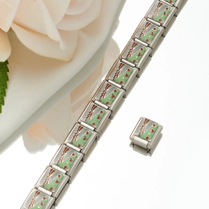 Detailed macro of modular Italian charm bracelet links with green enamel scenery detail