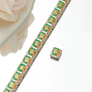 Macro shot of Italian charm bracelet with green enamel floral links and polished steel