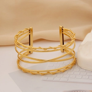 Detailed view of layered gold-plated stainless steel cuff bracelet with braided texture