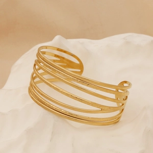 Detailed view of golden hammered texture on wide multi-layer stainless steel bangle