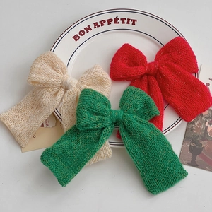 Three-piece set of knitted Christmas bow hair clips in red, green and off-white colors