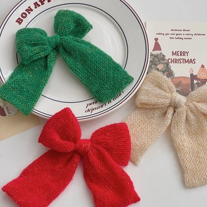 Three-piece knitted Christmas bows in red green and beige with gold glitter thread detail