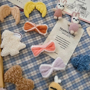 Assorted DIY plush Christmas accessories including bows, wings, and cute bunny dolls
