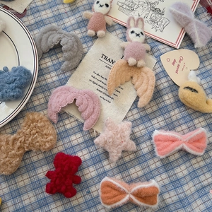Selection of cute plush hair accessories featuring bunnies, bears, stars, and bows on a table