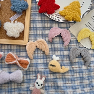 Detailed macro view of assorted plush DIY Christmas accessories and soft felt ornaments
