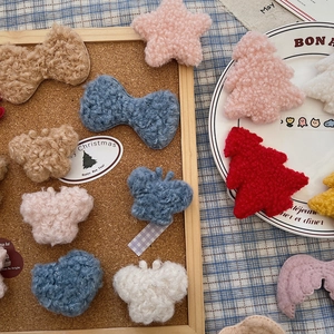 Close-up of soft plush DIY Christmas ornaments including stars, bows and trees