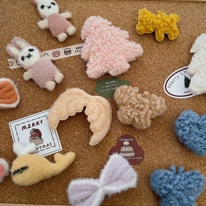 Close-up of assorted plush DIY Christmas ornaments on a cork background for crafts