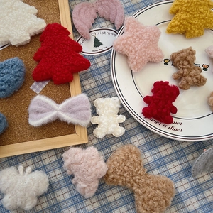 Close-up of assorted plush Christmas DIY patches including stars and trees for crafts