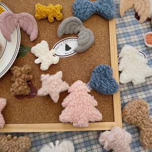 Assorted plush DIY Christmas accessories including teddy bears and stars in soft sherpa fleece