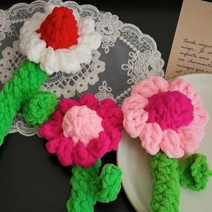Detailed view of hand-knitted crochet daisy flowers with soft wool yarn petals