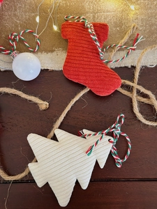 Detailed view of red and white corduroy Christmas tree and stocking ornaments on wood