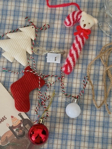 Detail of Christmas tree decor kit with velvet socks, candy canes, and LED light string