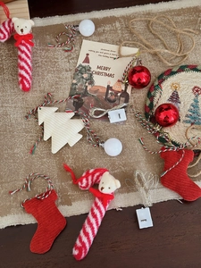 Detail view of DIY Christmas tree decor kit with knit socks, bear canes and LED lights