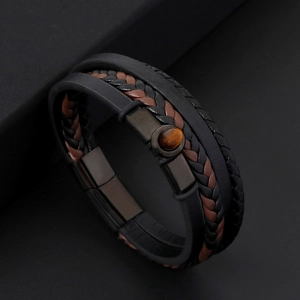 Macro shot of men's leather braided bracelet with tiger eye stone and magnetic clasp