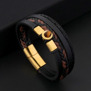 Detailed view of handmade leather bracelet featuring golden magnetic clasp and tiger eye stone