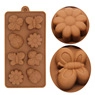 Detail view of brown silicone mold featuring butterfly and daisy flower shaped cavities
