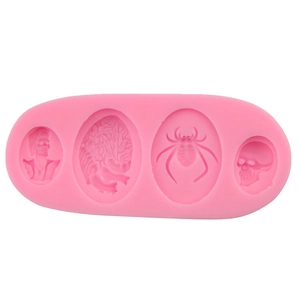 Pink silicone fondant mold with skull, spider, and brain patterns for Halloween cake baking