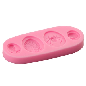 Pink silicone fondant mold featuring Halloween spider and skull shapes for cake baking