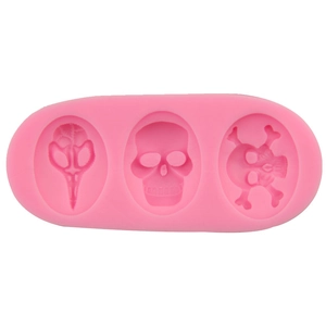 Pink silicone pirate skull fondant mold featuring bird and human skull shapes for DIY baking