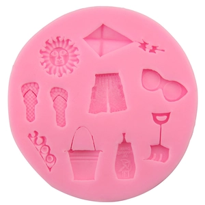 Pink silicone cake mold with summer beach patterns like sunglasses and sandals