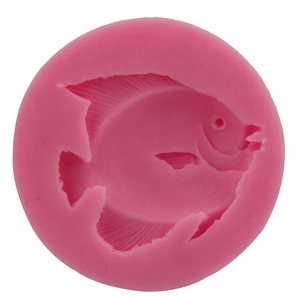 Pink round silicone mold for baking with a detailed tropical fish shape design