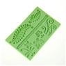 Detail of green silicone fondant mold with intricate leaves and dragonfly patterns