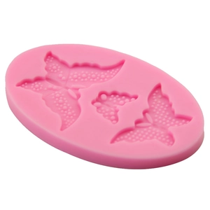 Pink silicone fondant mold with three detailed butterfly shapes for DIY cake baking