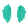 Macro detail of leaf-shaped fondant molds with green textured veins for cake baking