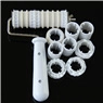 Detailed macro view of 9 adjustable plastic cutting wheels with a long handle for fondant